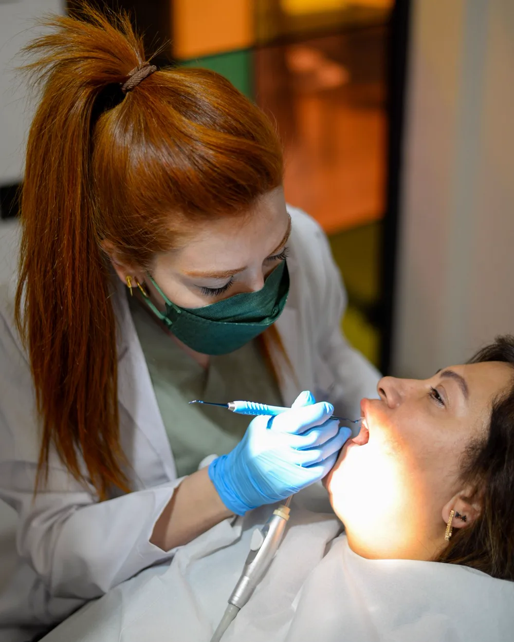 A dentist examining a patient's gums during a periodontal assessment