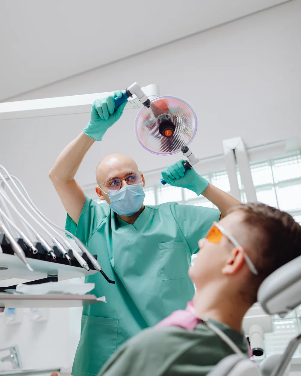 A dentist positioning the treatment light before placing a filling